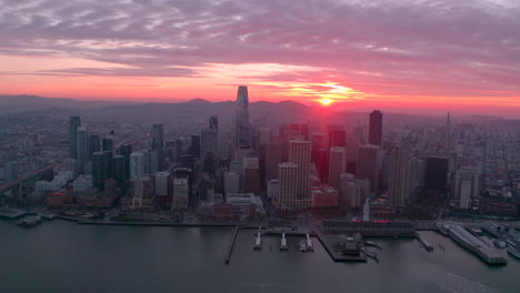 circling aerial shot of san francisco skyscrapers at sunset