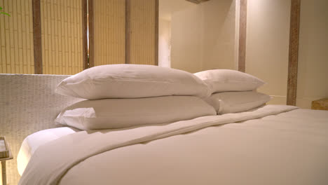 white pillows decoration on bed in luxury hotel resort bedroom