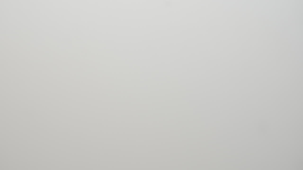 Tilting up to show three capsules of medical cannabis with dried marijuana blurred in background.