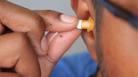 inserting earplugs or earbuds