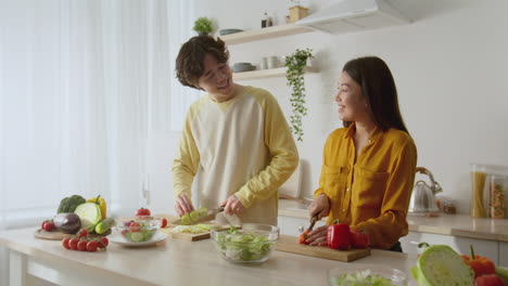 couple cooking a salad together