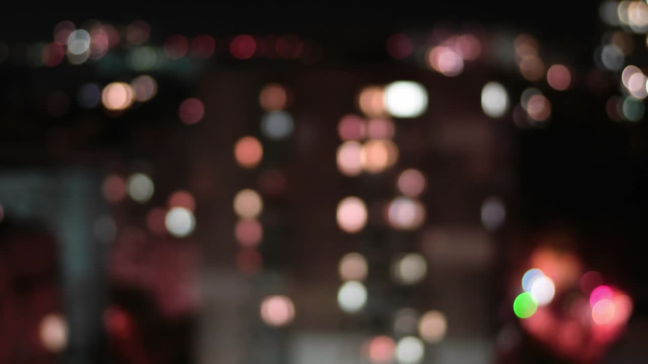 Cinematic background of bokeh blinking city lights in night