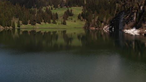 Flying-past-Swiss-flag-in-beautiful-lakeside-area