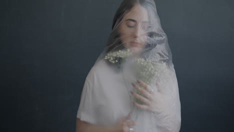 woman covered in plastic with flowers