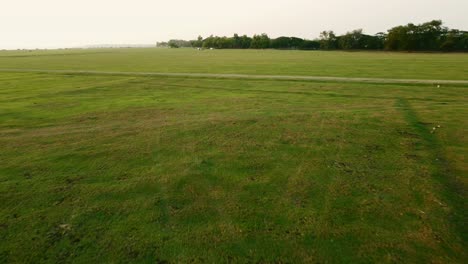 aerial view shot of landscape at the end of pa sak jolasid dam with green grass and water