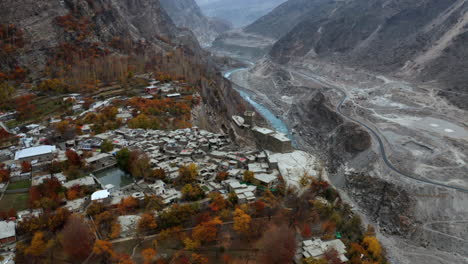 aerial circling above ancient altit fort, hunza valley in autumn colors