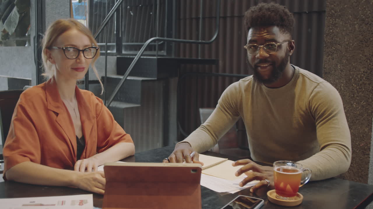 Portrait of Diverse Colleagues Working In Modern Cafe