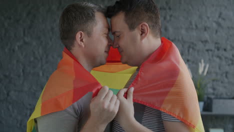 happy gay couple with pride flag