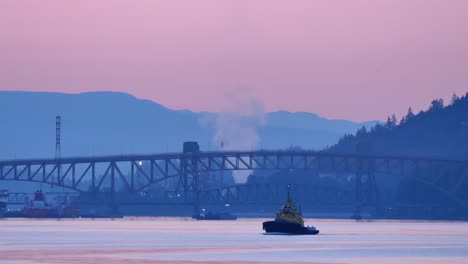 tugboat cruising in the harbour on an early morning static