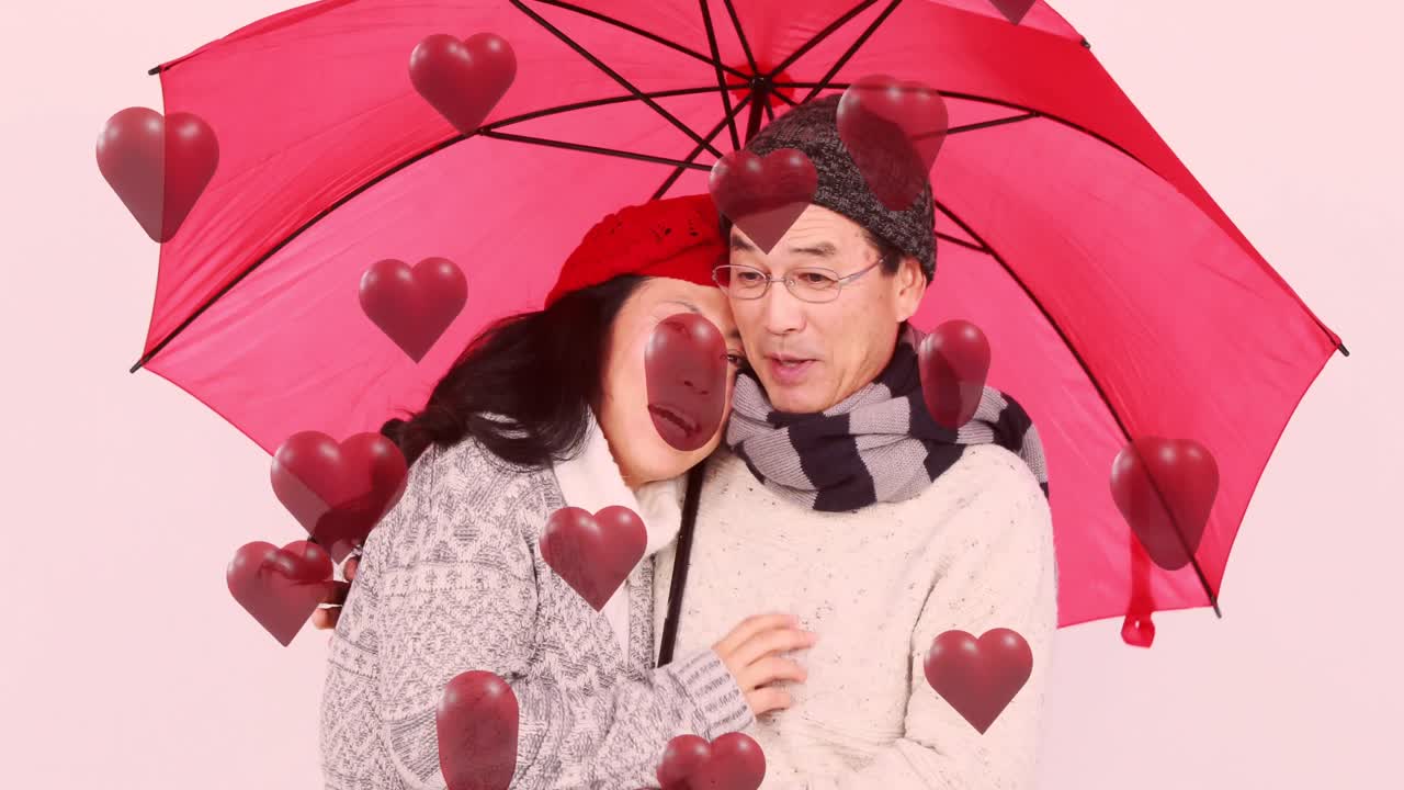 분홍색 우산과 함께 사랑에 빠진 커플 위에 빨간 심장의 애니메이션