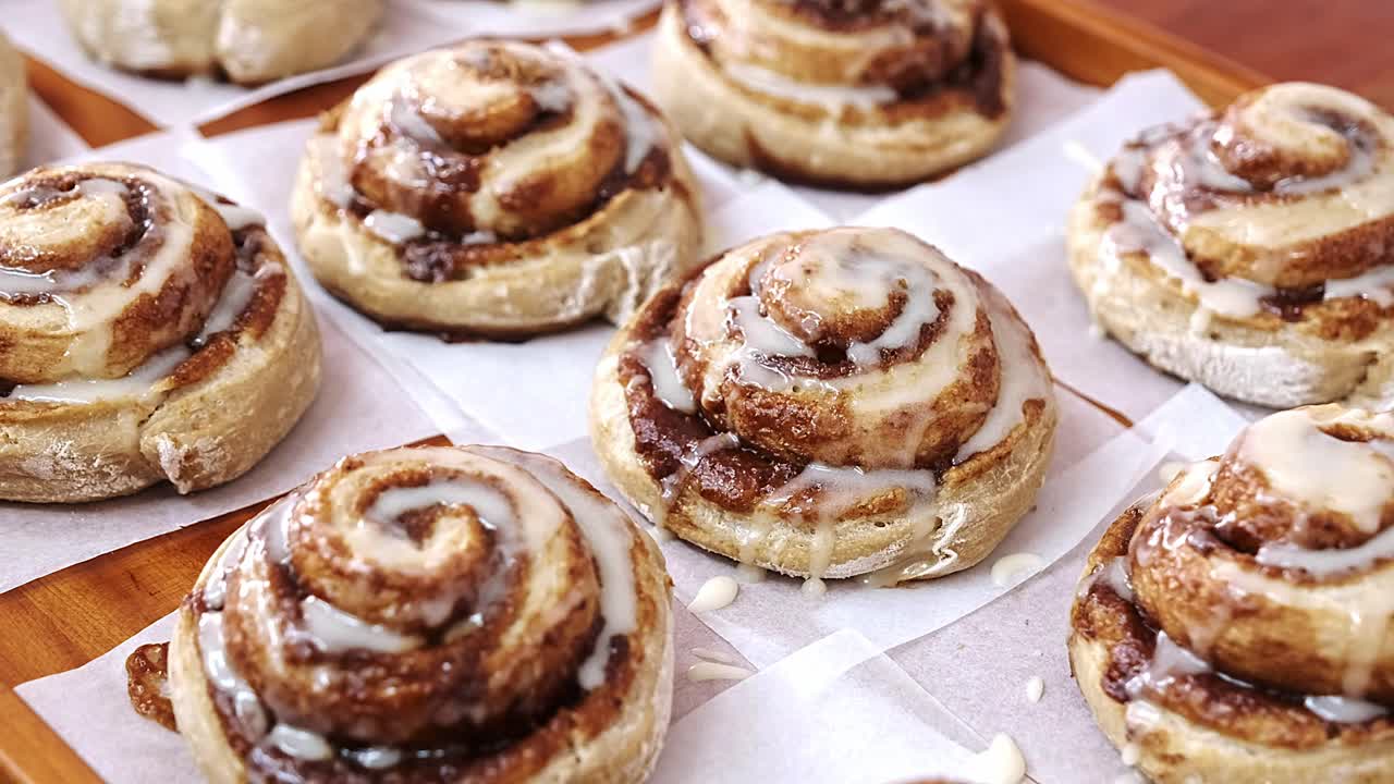 Sugar glazed cinnamon buns on parchment paper