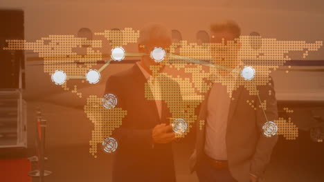 connecting dots over world map against two caucasian businessmen using smartphone at airport runway