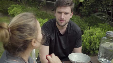 people sitting at table and talking outdoors