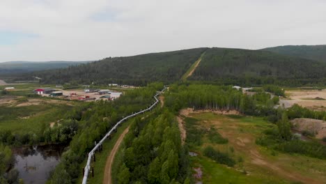 4k drone video of trans alaska pipeline crossing under roadway in fairbanks, ak during sunny summer day-1