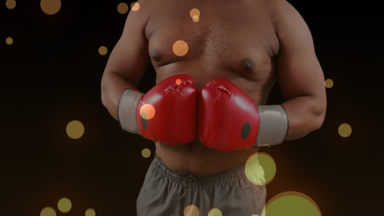 Boxer holding gloves while camera pulling back, gold bokeh drifting, showing form for fitness ads