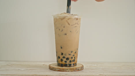 Taiwan-milk-tea-with-bubble-and-cheese-burned-on-wood-table