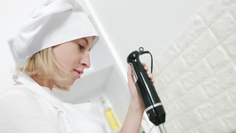 chef using a handheld blender