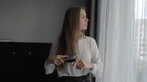 beautiful entrepreneur woman brush hair in early morning, front view