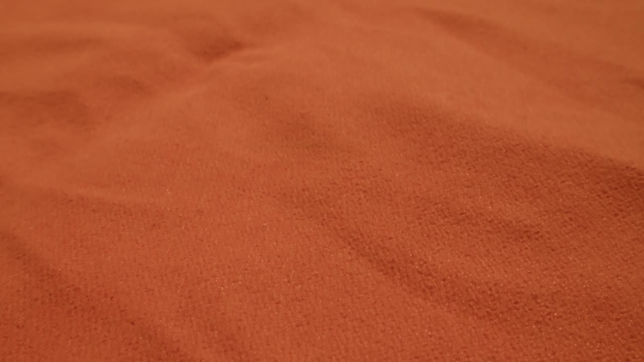 Close Up of Orange Textured Fabric with Soft Folds