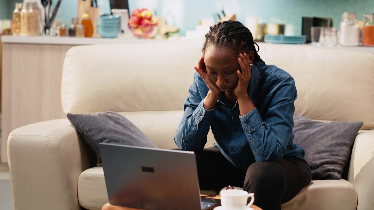 Headache on black woman working from home and feeling overwhelmed