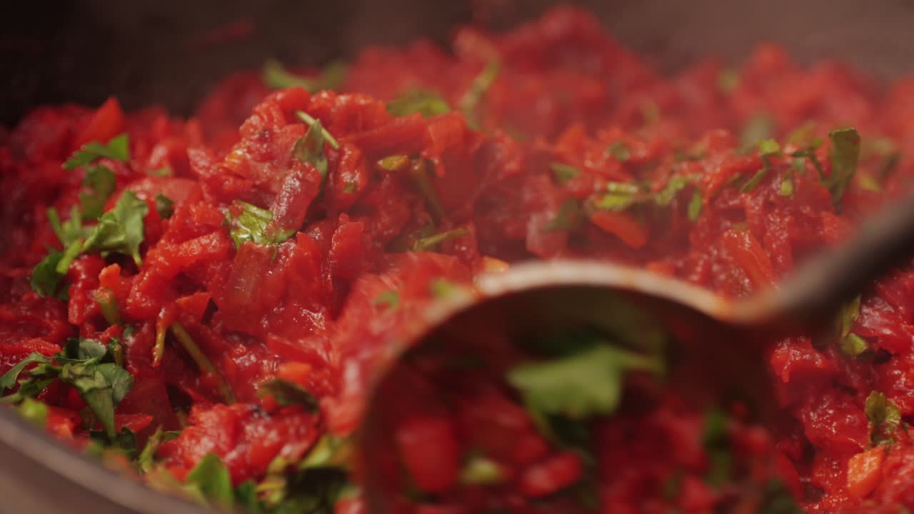 Cooking traditional national Russian, Ukranian soup Borsch close-up. Boiling red soup with vegetables and turkey meat and spices. Special red for Borsh from beet, carrot and tomatoes pasta