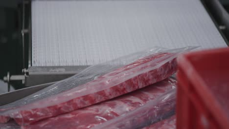 costillas que salen de la máquina de envasado