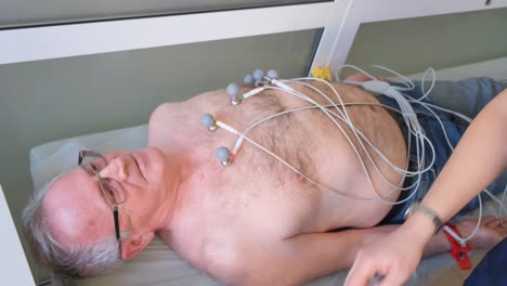close-up of the hands of an ultrasound doctor performing an ultrasound of the abdominal cavity on a patient with a modern scanner. modern medical diagnostic equipment. vertical video.