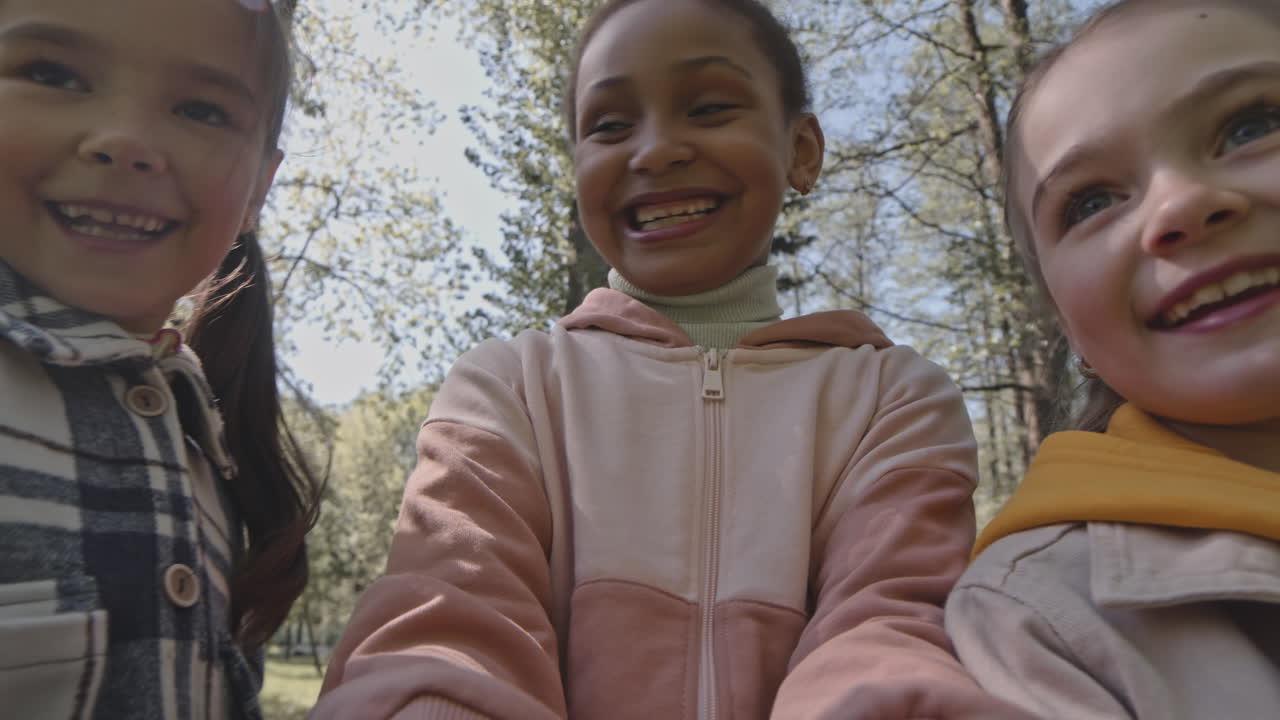 Three smiling girls outdoors