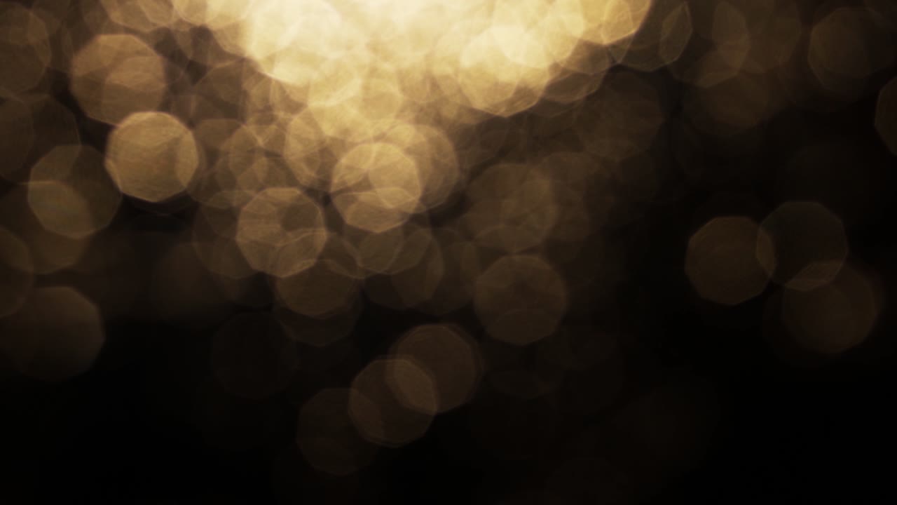 Luci Bokeh Dorate Astratte Che si Muovono su Sfondo Nero