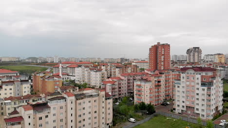 Aerial-city-view-with-apartments-houses-and-traffic-on-the-roads-on-a-winter-day