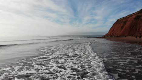 aerial low flying tracking waves across to orcombe point beach