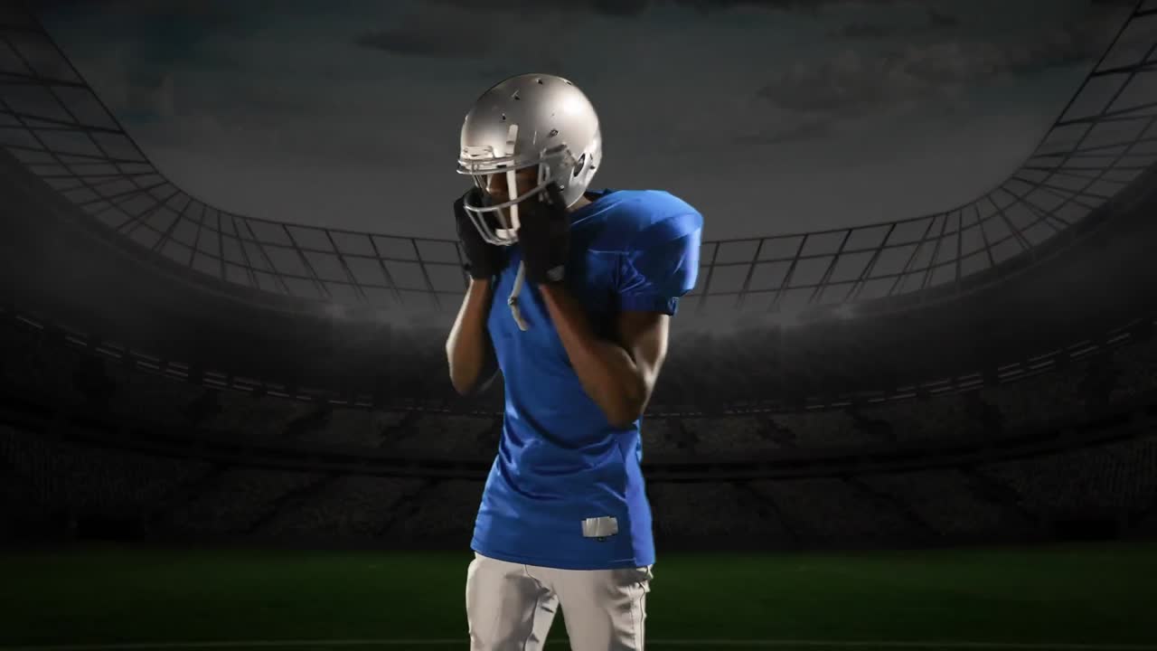 Professional American football player standing in front of a sports stadium
