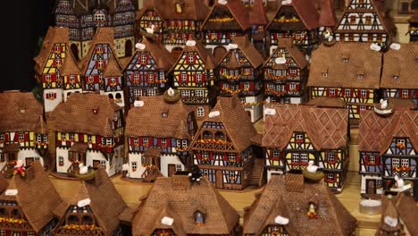 series of toy village pieces of alsace architecture at festive christmas market in strasbourg, france europe