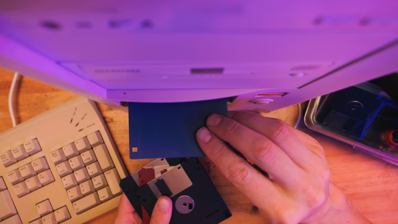 Using diskette for old computer. Music recorder, playing retro computer games. Vintage device for office, obsolete technology. . High quality 4k footage