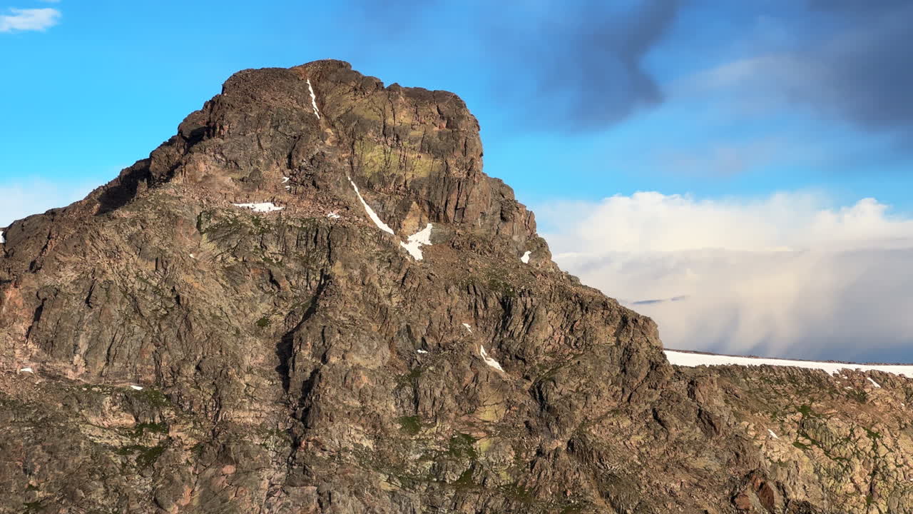 Close up Mount of the Holy Cross 14er peak north ridge half-moon pass trail spring summer Rocky Mountains Colorado blue sky clouds landscape nature view of 14er summit snow field cornice static