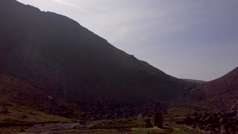 pan right in the middle of a rock mine in the green and sunny mountains of ireland.