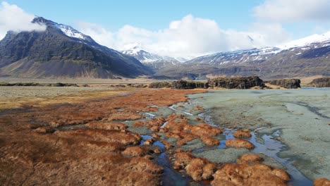 Icelandic-river-and-waterfall-with-mountains-on-the-background-drone-show-in-4K-9