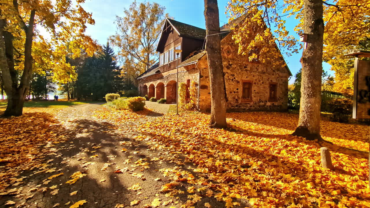 Charming house nestled by a lake in Lielvārde, surrounded by vibrant autumn forest colors