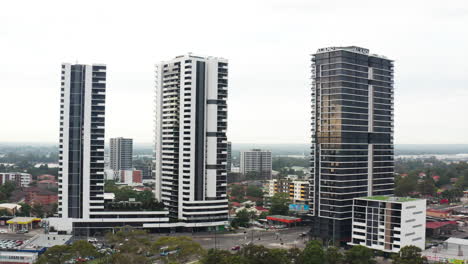 Aerial-drone-shot-flying-around-a-busy-intersection-amongst-high-rise-buildings-in-Liverpool-Sydney-Australia