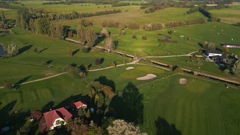 Fantastic-aerial-view-flight-of-golf-course-in-the-forest-woods