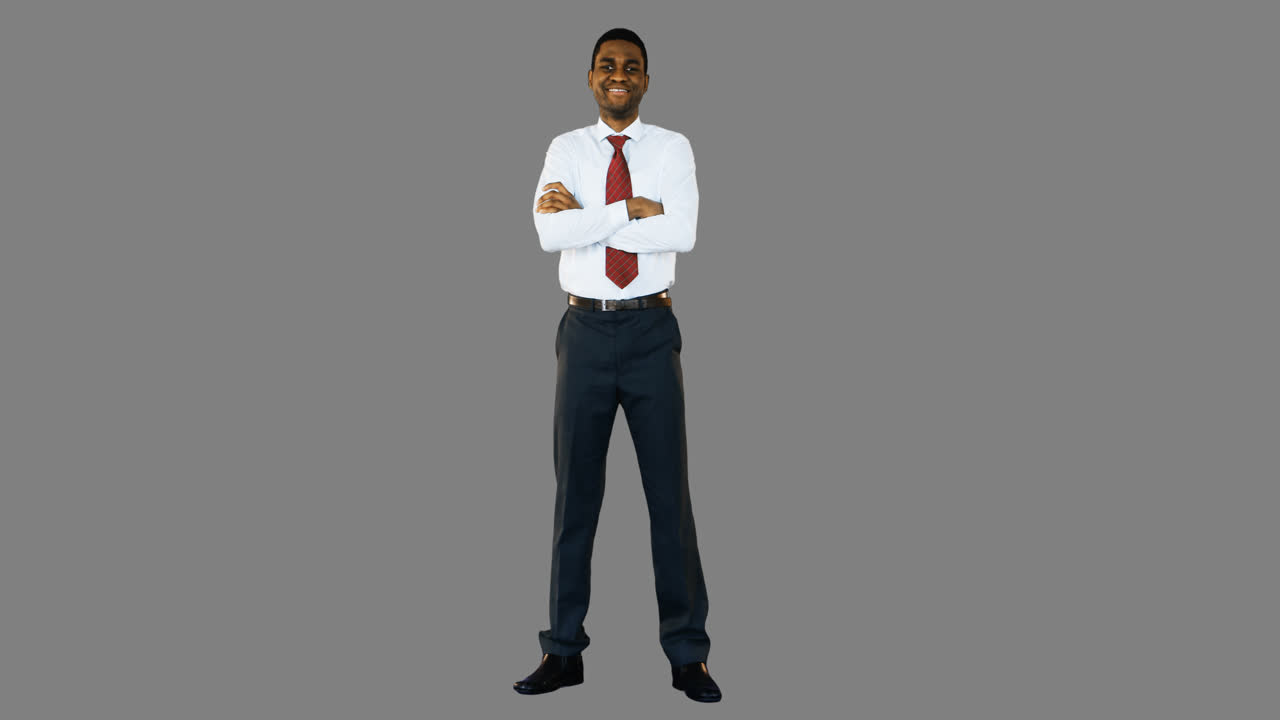 Portrait of smiling businessman standing with arms crossed