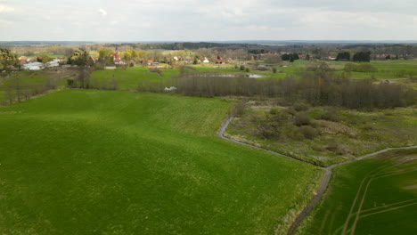 fly past over lush green fields of pieszkowo poland