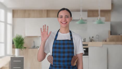 happy indian housewife waving hello