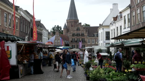 people walking on road at street market in netherlands on cloudy day. 4k