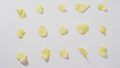 Close-up-of-potato-chips-with-copy-space-on-white-surface