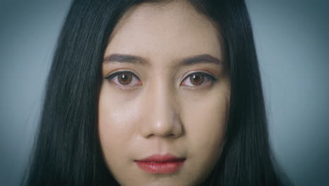 A-close-up-portrait-on-a-beautiful-Asian-woman-face-looking-at-the-camera,-biometric-retina-recognition-algorithm-technology-scanning-concept