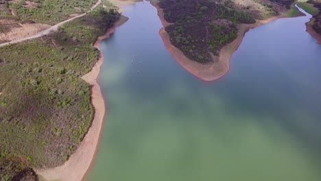 A-lake-near-Albufeira,-Portugal,-with-people-SUP-ing