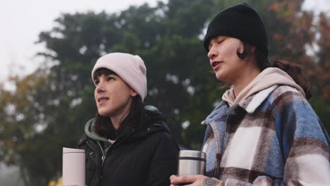 girl, together and talking at camp with coffee