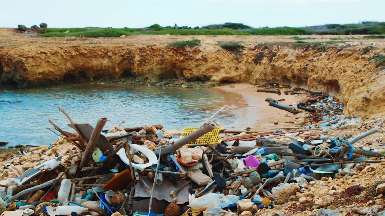 Trash piled up on tropical Caribbean beach alcove