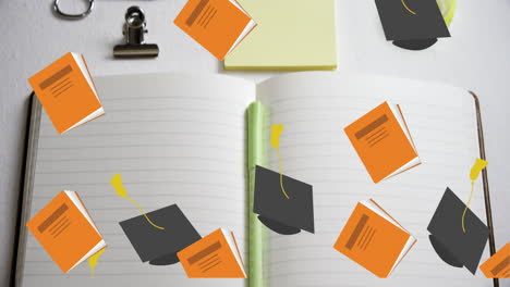 open notebook lies on a desk in a school setting, surrounded by graduation caps